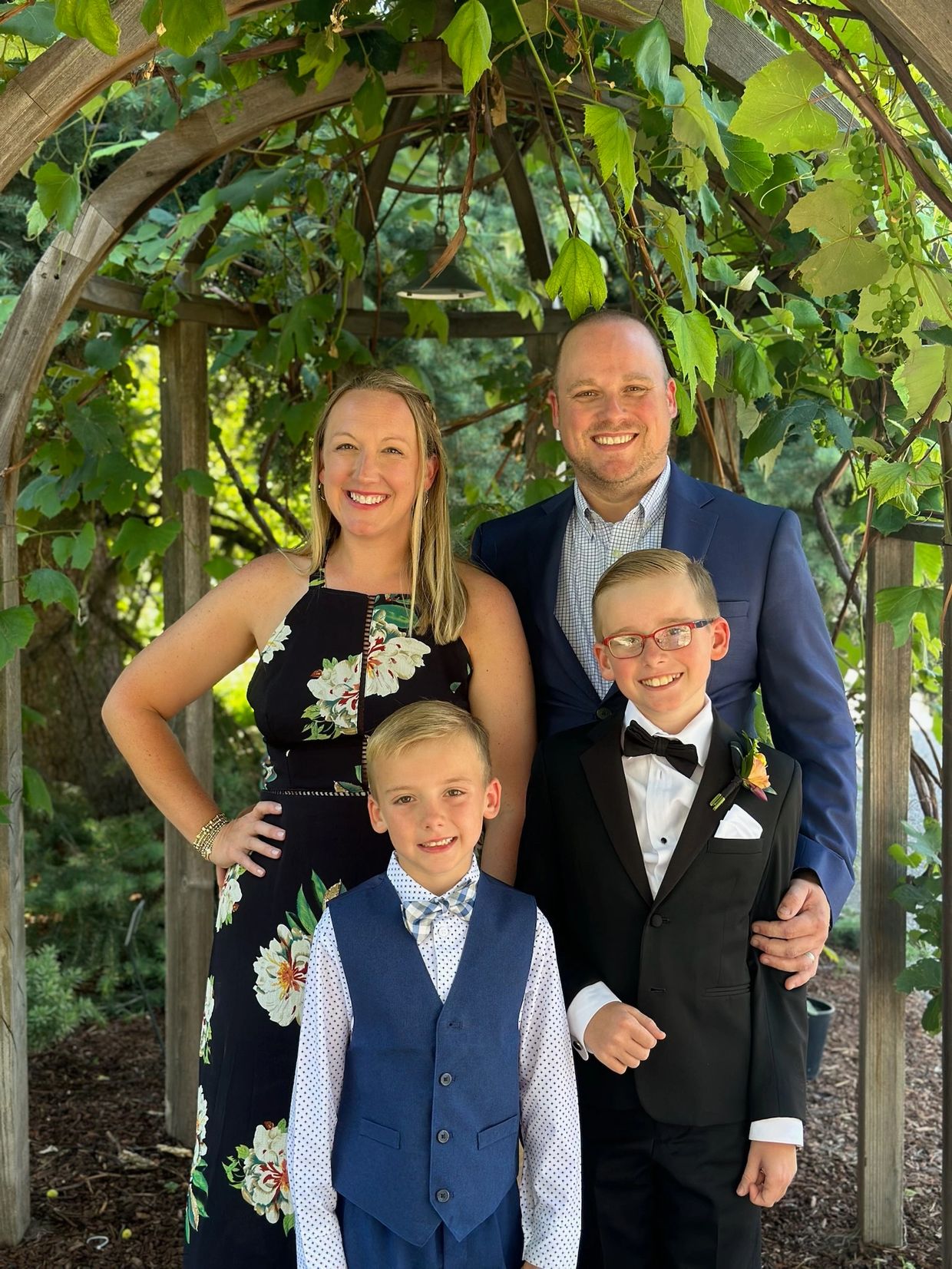 A family posing for a picture in formal wear.